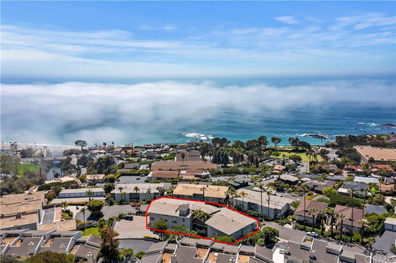 Aerial view of residential area with ocean in background.