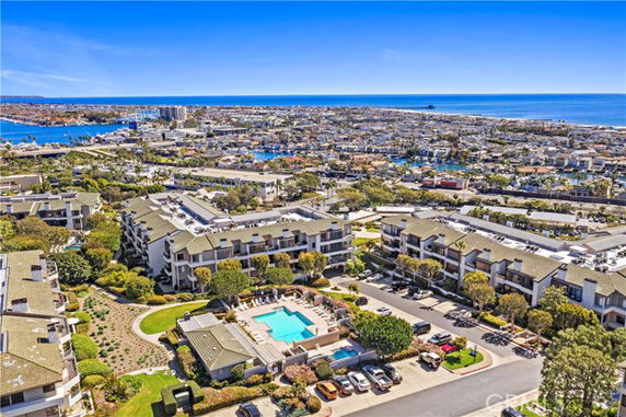Panoramic view of a residential area with multiple apartment buildings and a central swimming pool.