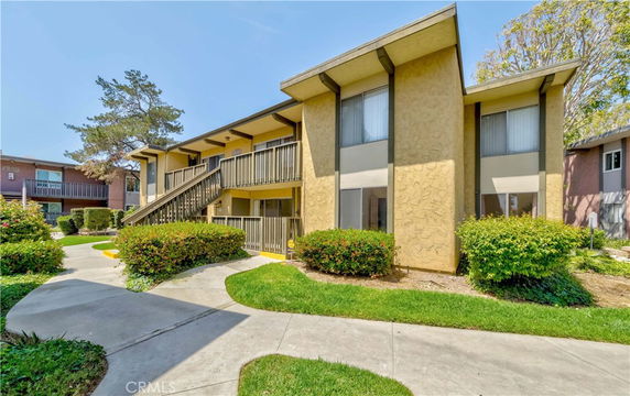 Front view of a two-story residential building with exterior staircases.