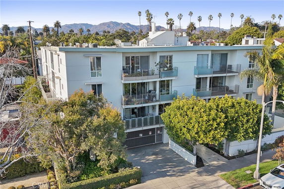 Front view of a multi-story apartment building with balconies.