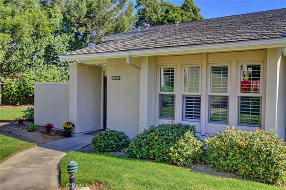 Front view of a single-story house with a gable roof and white exterior.