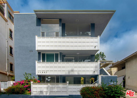 Front view of a multi-story residential building with balconies.