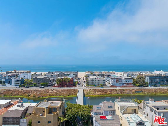Panoramic view of coastal residential area with ocean in the background.