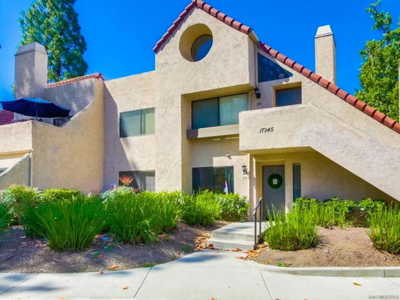 Front view of a two-story house with unique architectural design and sloped roof.
