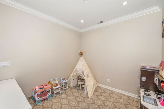 Interior view of an indoor play area with toys and a small tent.