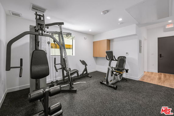 Indoor gym area with exercise equipment.