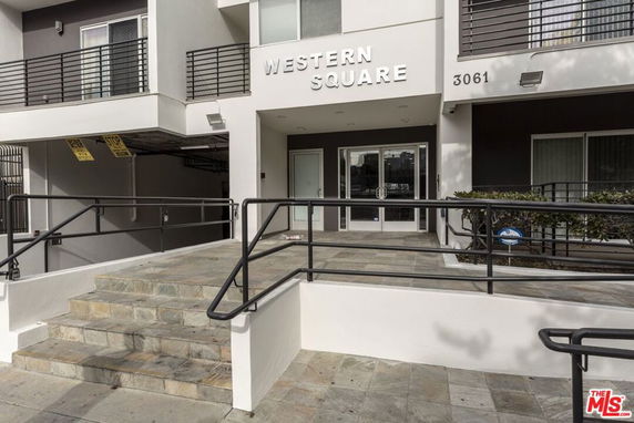 Front view of a building entrance with stairs and a ramp