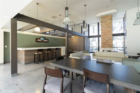 Interior of a recreational room with seating and a bar area.