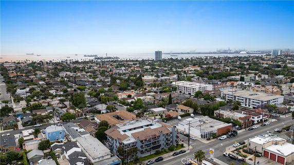 Panoramic view of a neighborhood with distant view of water and buildings.