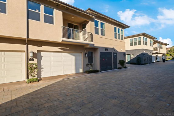 Front view of a modern two-story townhouse with garages.