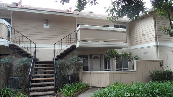 Front view of a two-story residential building with balconies.
