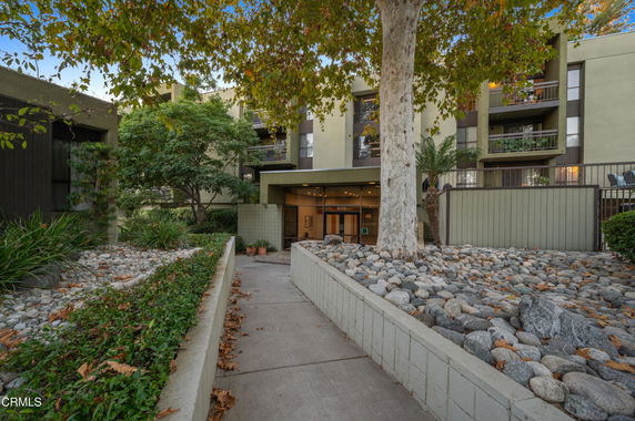 Front view of a multi-story residential building with balconies.