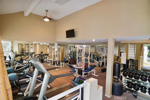 Indoor gym area with various fitness equipment and weights.