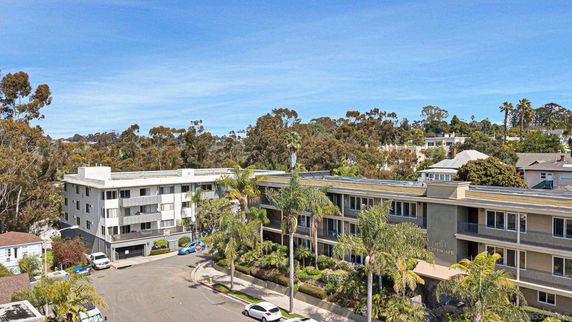 View of apartment buildings surrounded by trees.
