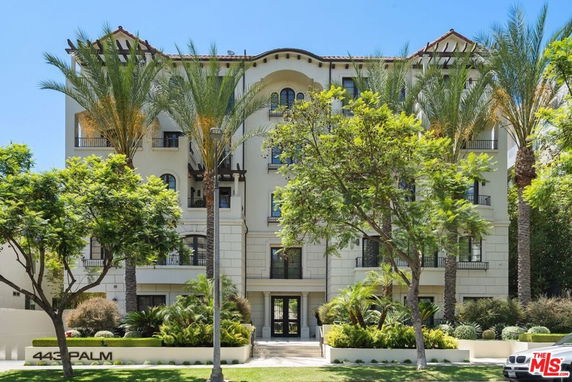 Front view of a multi-story residential building with an elegant facade.