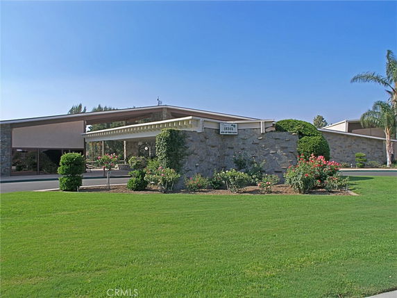 Front view of a building with a stone facade and flat roof.