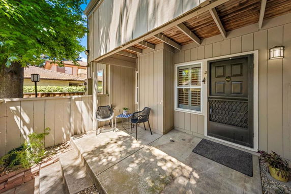 Front view of a house entrance with a small patio.