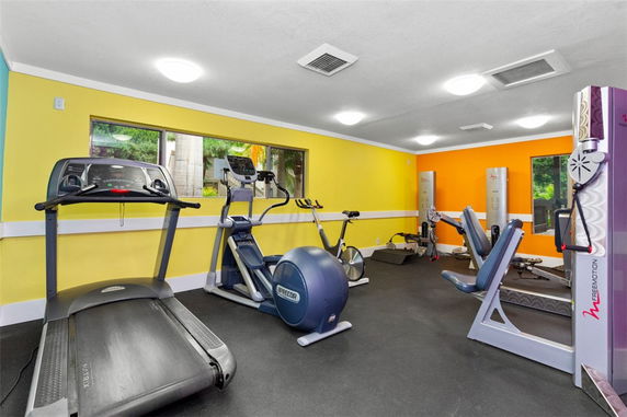 Indoor gym area with various exercise equipment.