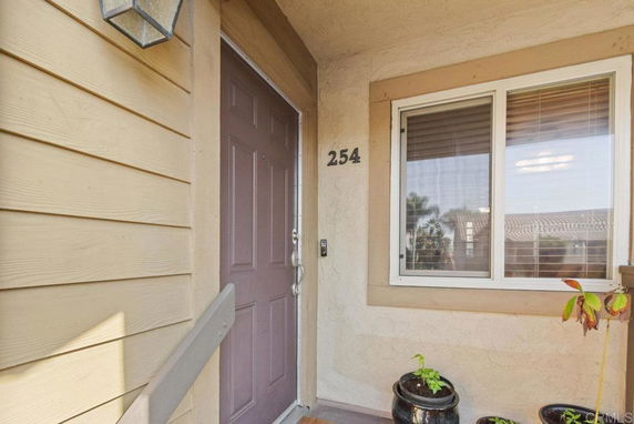 Front view of an entryway with a door and window in a residential building.