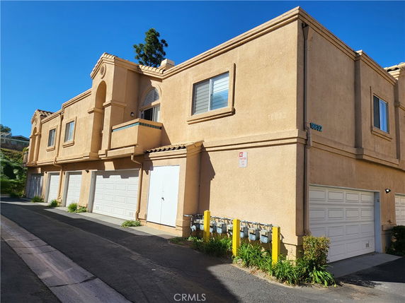 Front view of a two-story residential building with garages.