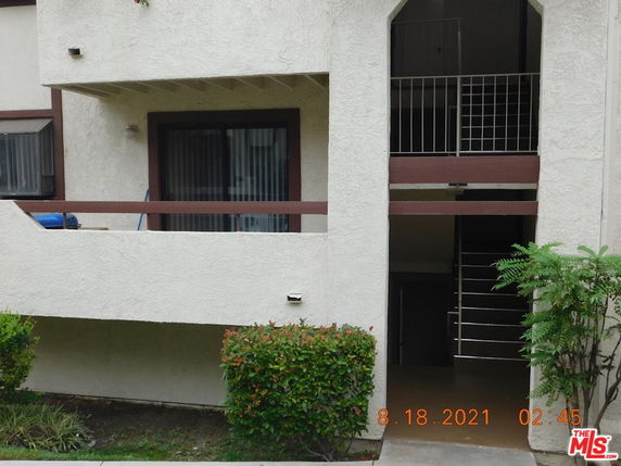 Front view of a multi-story building with balconies.