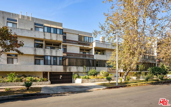 Front view of a multi-story residential building with balconies.
