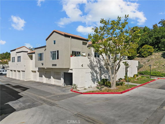 Front view of a multi-story building with multiple garage doors.