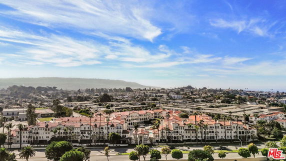 Panoramic view of a residential area with multiple white buildings with red roofs.