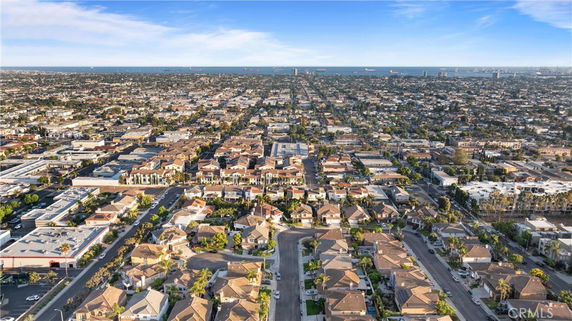 Aerial panoramic view of a residential neighborhood with houses and buildings extending towards the horizon.
