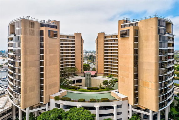 Front view of a multi-story building complex with circular design elements.