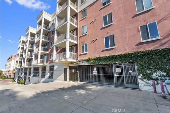 Front view of a multi-story residential building with balconies.