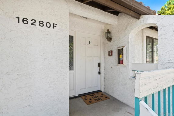 Front door entrance of a house with an address sign.