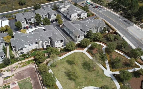 Aerial view of a residential complex with multiple buildings and surrounding greenery.
