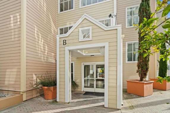 Front view of a multi-story building entrance with a covered entryway labeled 'B'.
