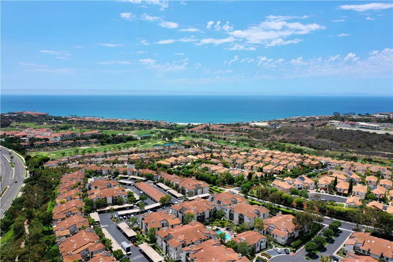 Panoramic view of residential area with ocean in the background.