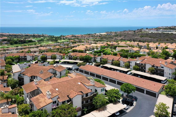 Panoramic view of a residential area with houses and ocean in the background
