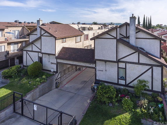Front view of a residential building with two stories and a driveway.