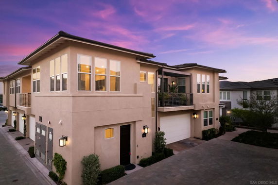 Front view of a modern two-story house at dusk.