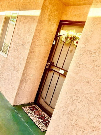 Entrance view of a house with a floral decorated front door.