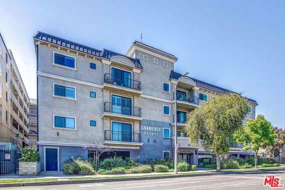 Front view of a multi-story apartment building with balconies.