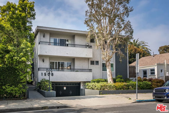 Front view of a multi-story residential building with balconies.