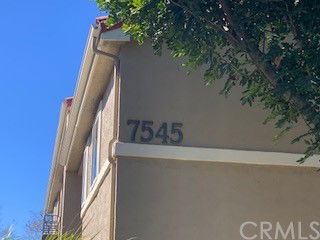 Side view of a building with the number 7545 on its exterior wall.