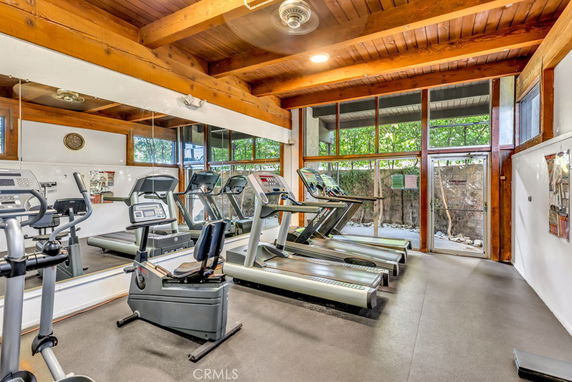 Indoor gym area with exercise equipment, including treadmills and a stationary bike.