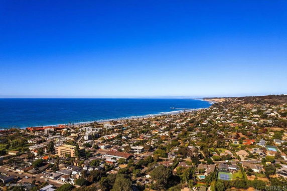 Panoramic view of a coastal city with buildings near the ocean.