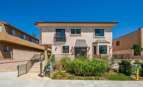 Front view of a two-story house with a railing and stairs