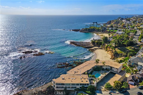 Panoramic view of coastal area with buildings, beach, and ocean.