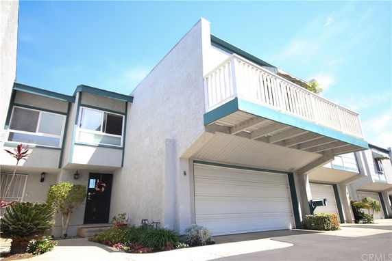 Front view of a house with a balcony and garage.