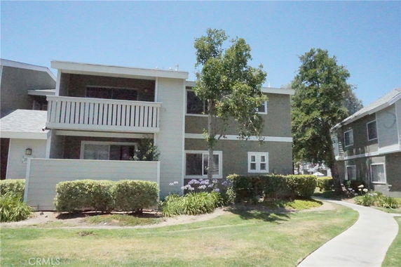 Front view of a two-story residential building with a balcony.