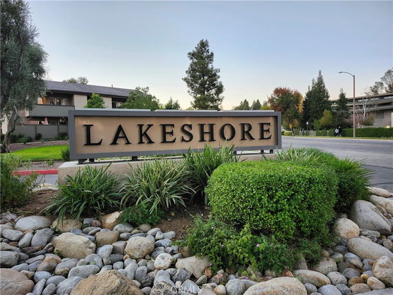 Front view of a building with a sign labeled 'Lakeshore' and surrounded by greenery.