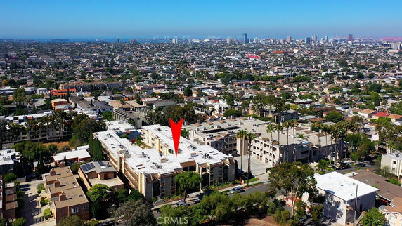 Aerial view of a large cityscape with buildings and a clear sky.